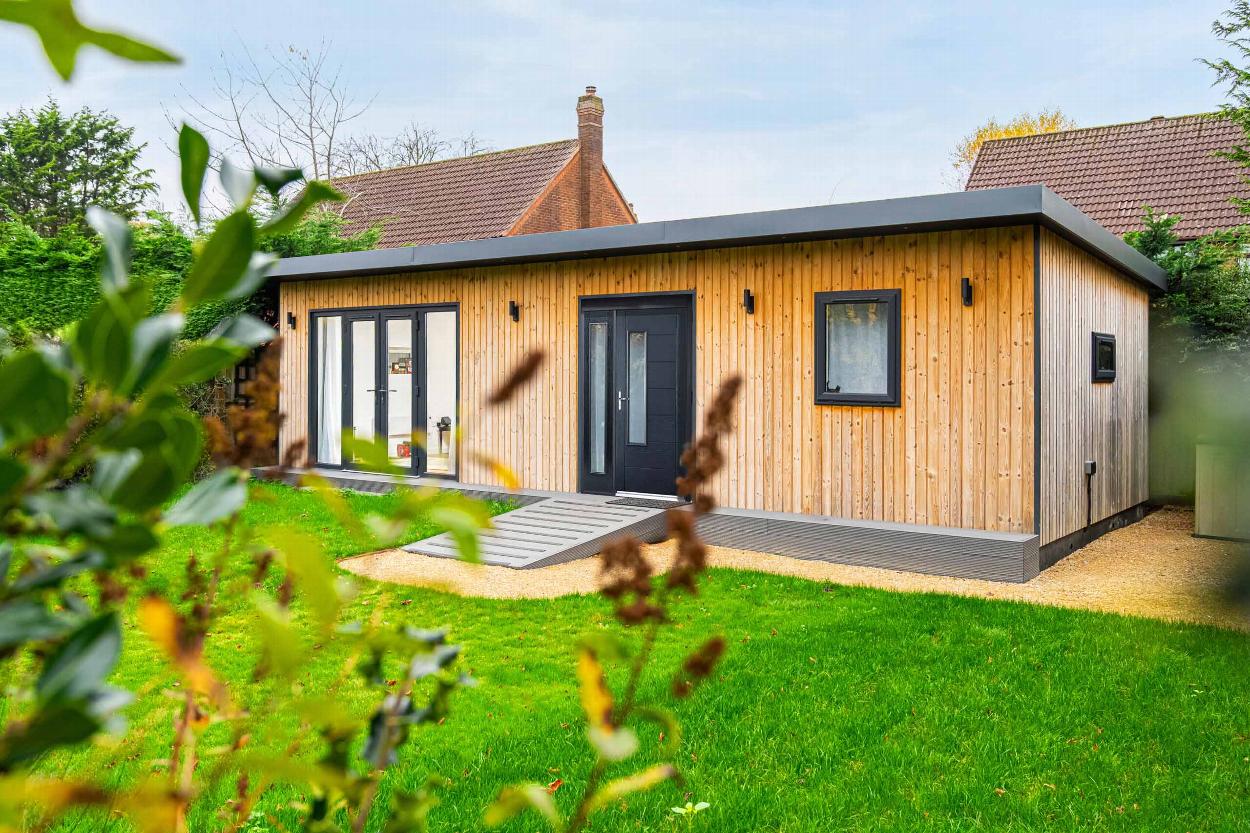 Modern timber-clad annexe in a landscaped garden